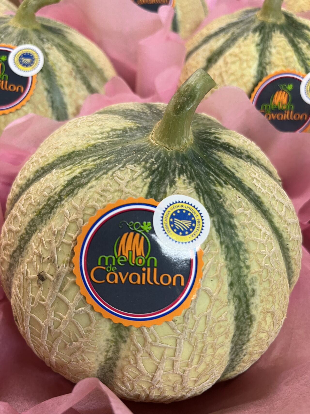 Cavaillon melon - An iconic speciality of the Provençal terroir Cavaillon melon with its official label, showcased in its packaging, a symbol of the Provençal terroir.