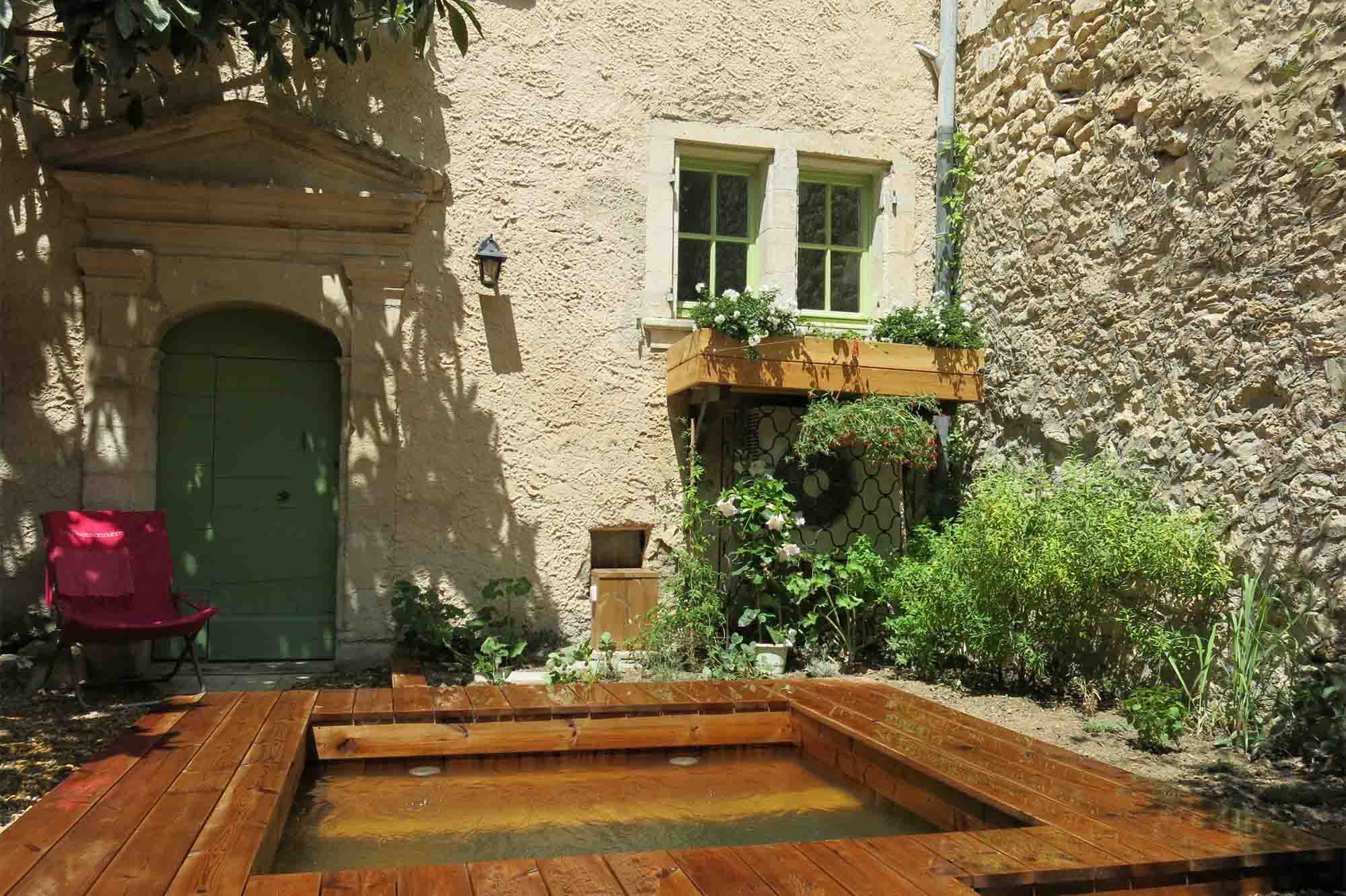 Enclosed garden with natural wooden pool in La Buissonnière