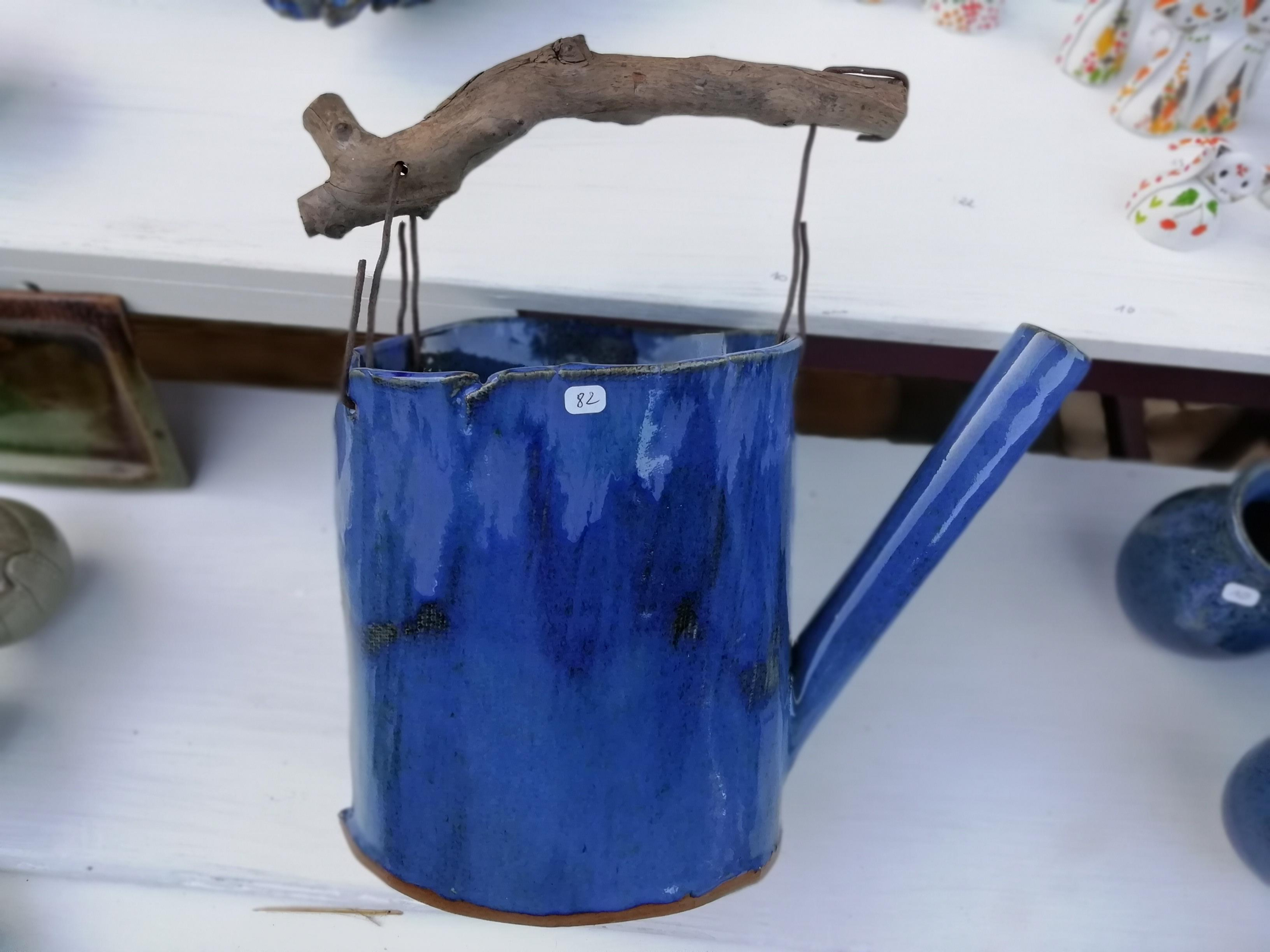 Blue ceramic watering can with driftwood handle, unique piece from Poterie de Pierroux