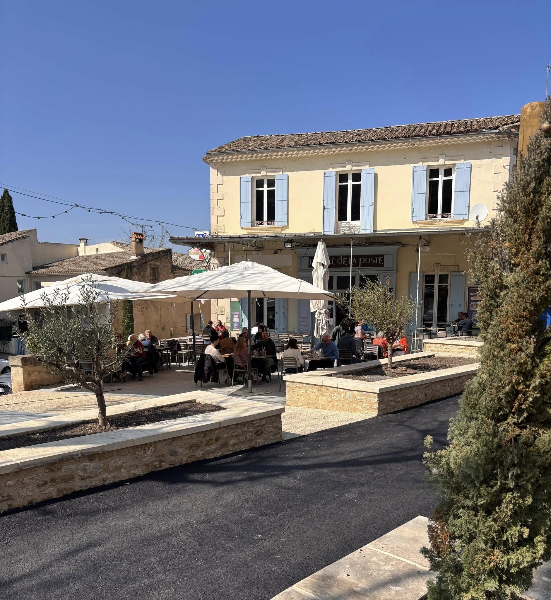 Terrace of Café de la Poste in Robion, in the heart of the Luberon Sunny terrace of Café de la Poste in Robion, in the Luberon