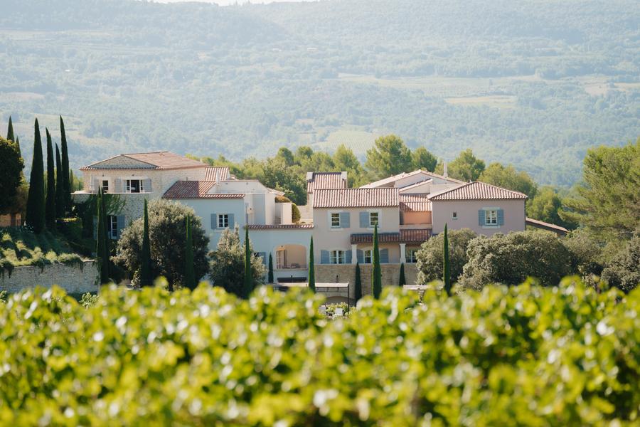 View of Coquillade Provence surrounded by vineyards in the Luberon