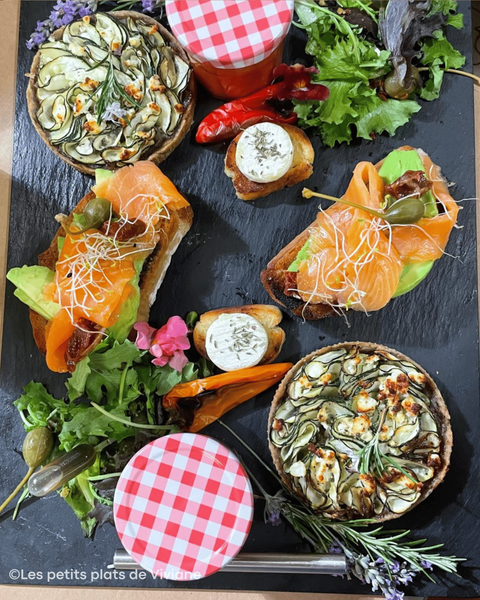 Gourmet platter with vegetable tarts, salmon toasts, salad and a verrine, created by Les Petits Plats de Viviane