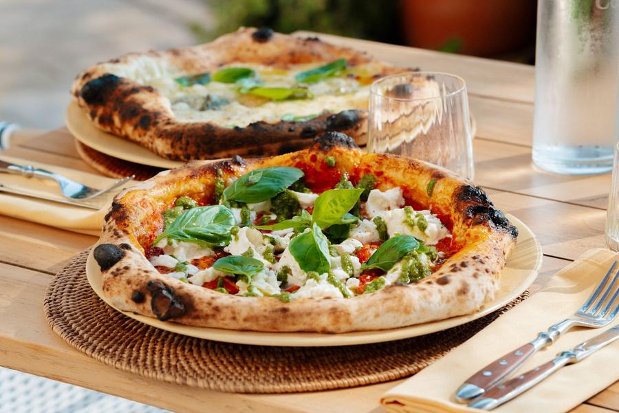 Wood-fired Neapolitan pizza topped with mozzarella and basil, served at Cipressa restaurant in Coquillade Provence