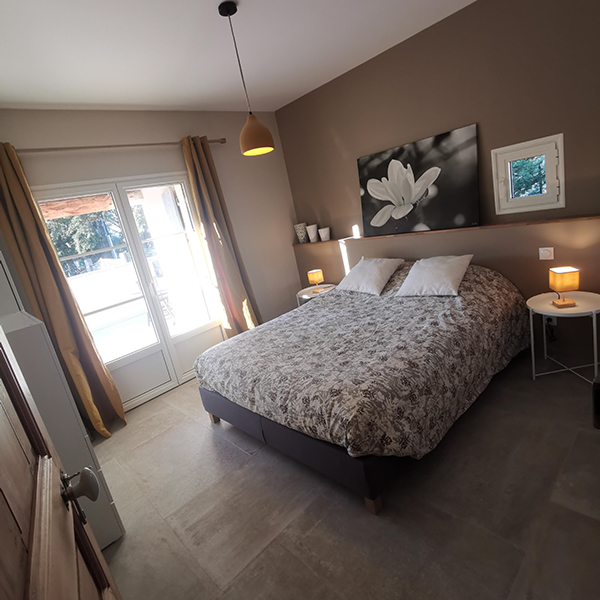 Bright double bedroom with a comfortable bed at Mas d’Anaé, a holiday rental in the Luberon