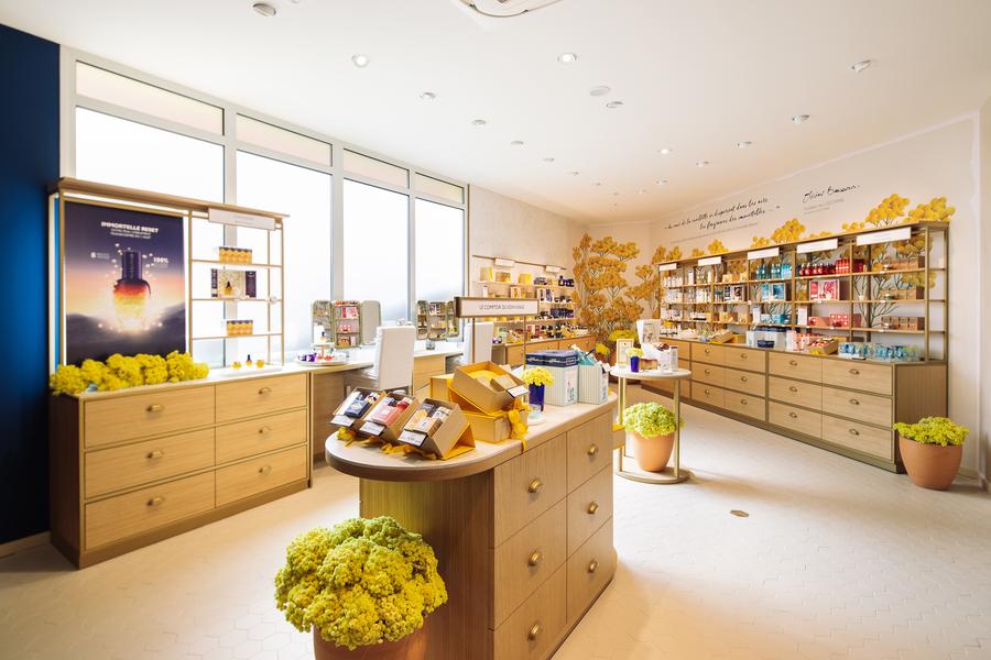 Bright interior of the L'Occitane en Provence boutique, showcasing the brand's signature cosmetics and fragrances.