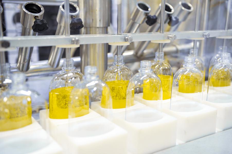 L'Occitane en Provence production facility with a bottle-filling process for cosmetic care products.