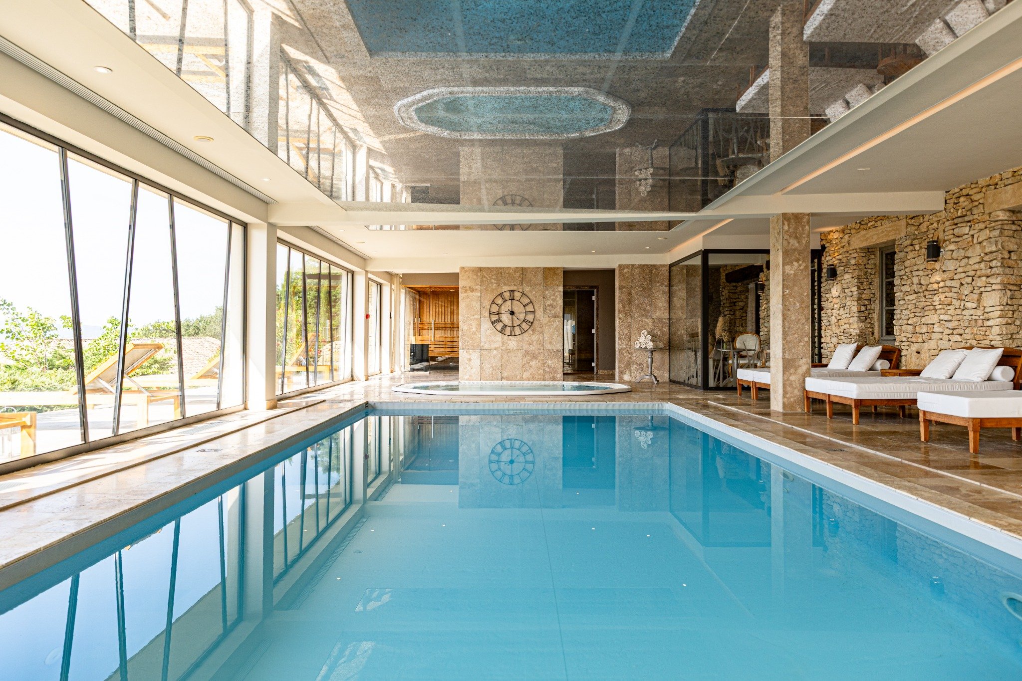 Indoor swimming pool and wellness area at Mas des Herbes Blanches in Joucas