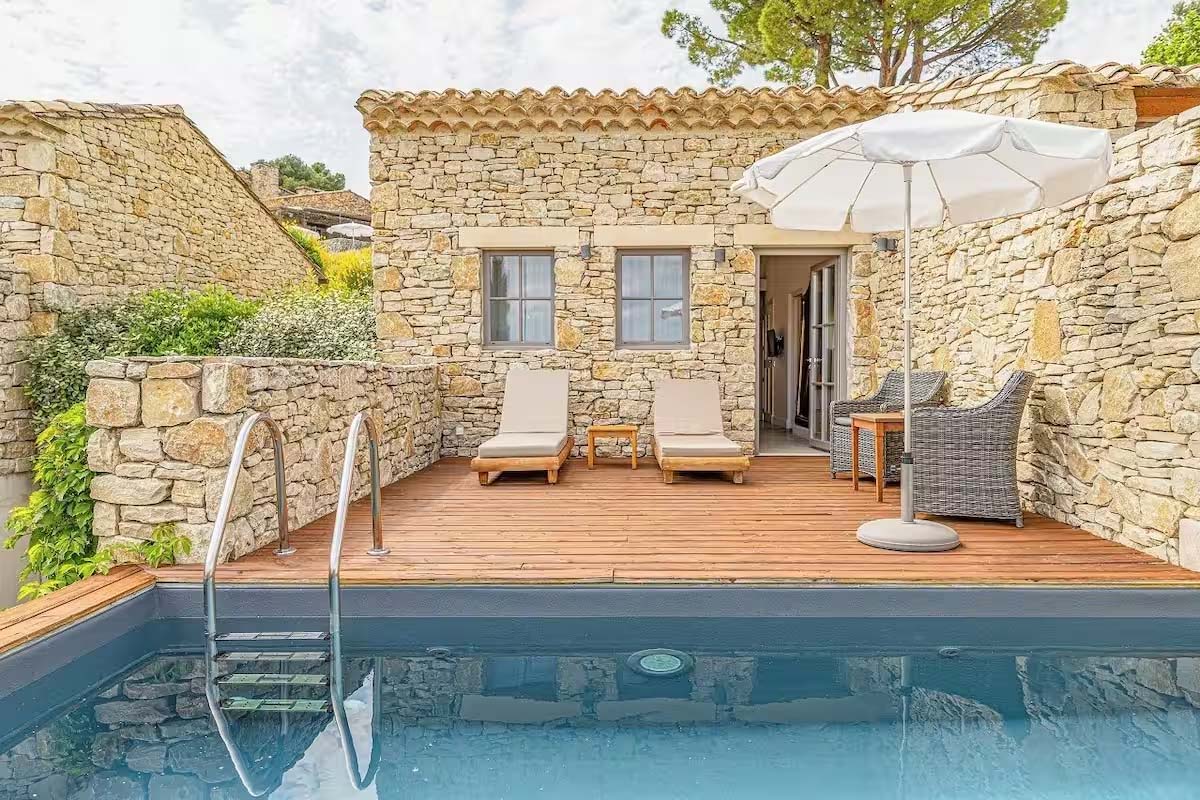 Private swimming pool adjoining a room at Mas des Herbes Blanches in Joucas, Luberon