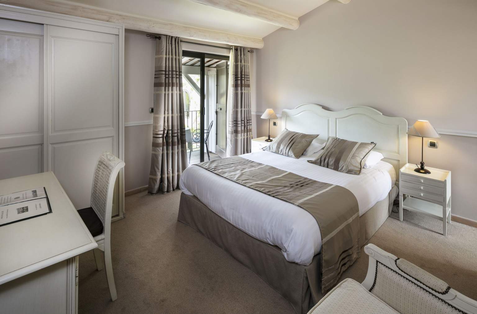 Bright bedroom at Le Mas de Guilles with double bed and soft decor