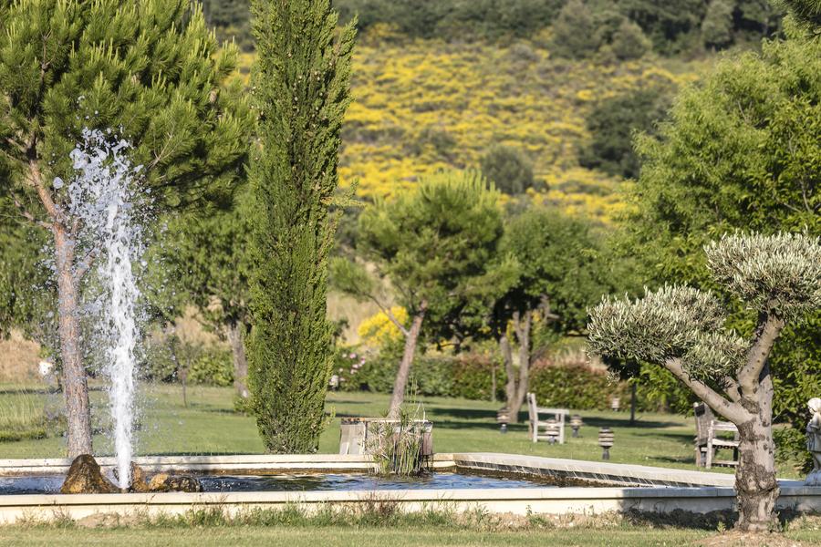 Water basin and landscaped park at Le Mas de Guilles in the Luberon