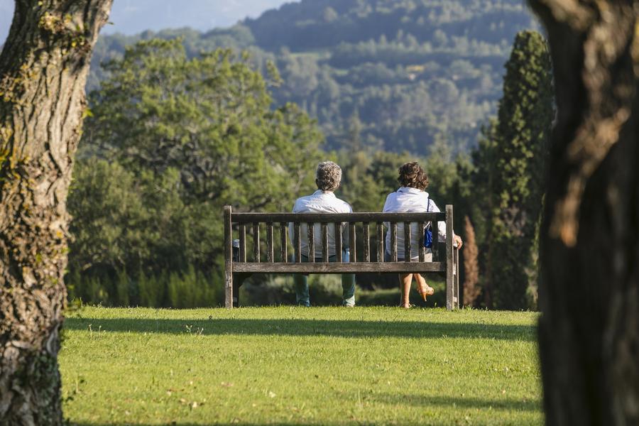 Couple sitting on a bench in the park at Le Mas de Guilles