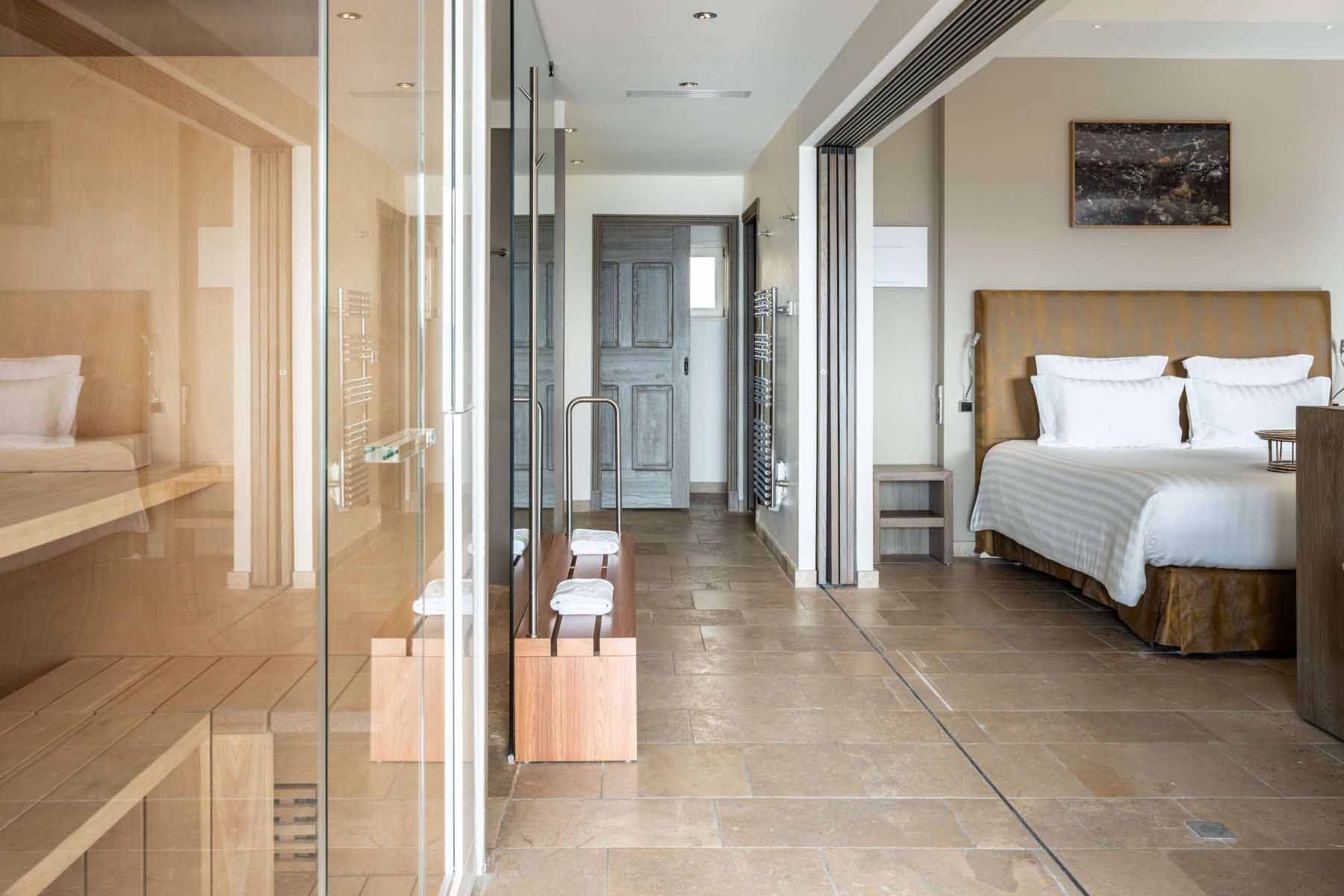 Luxury suite with bedroom area and sauna at Coquillade Provence