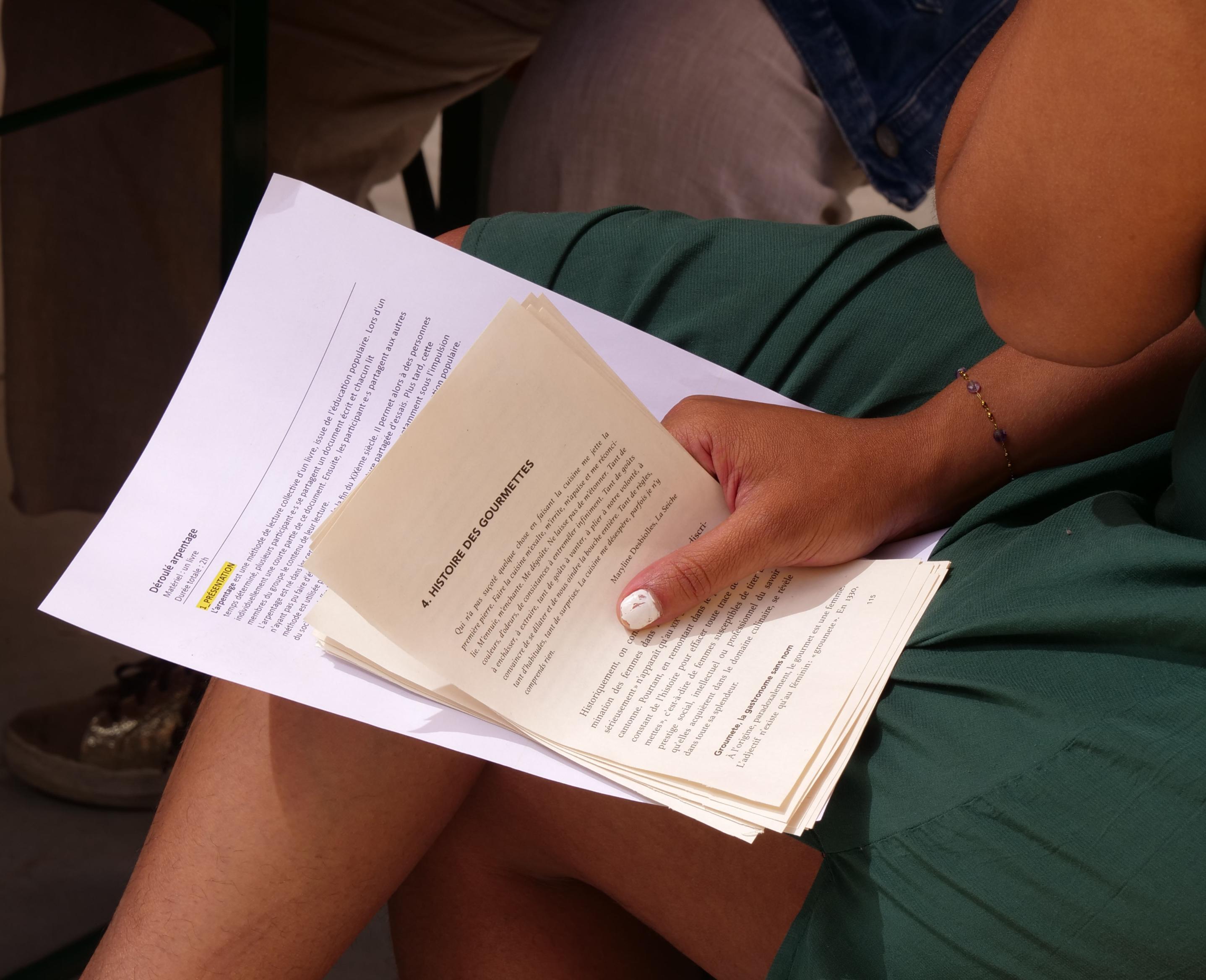 Participant browsing a book during a collective and participatory reading workshop about food at Festival Confit!
