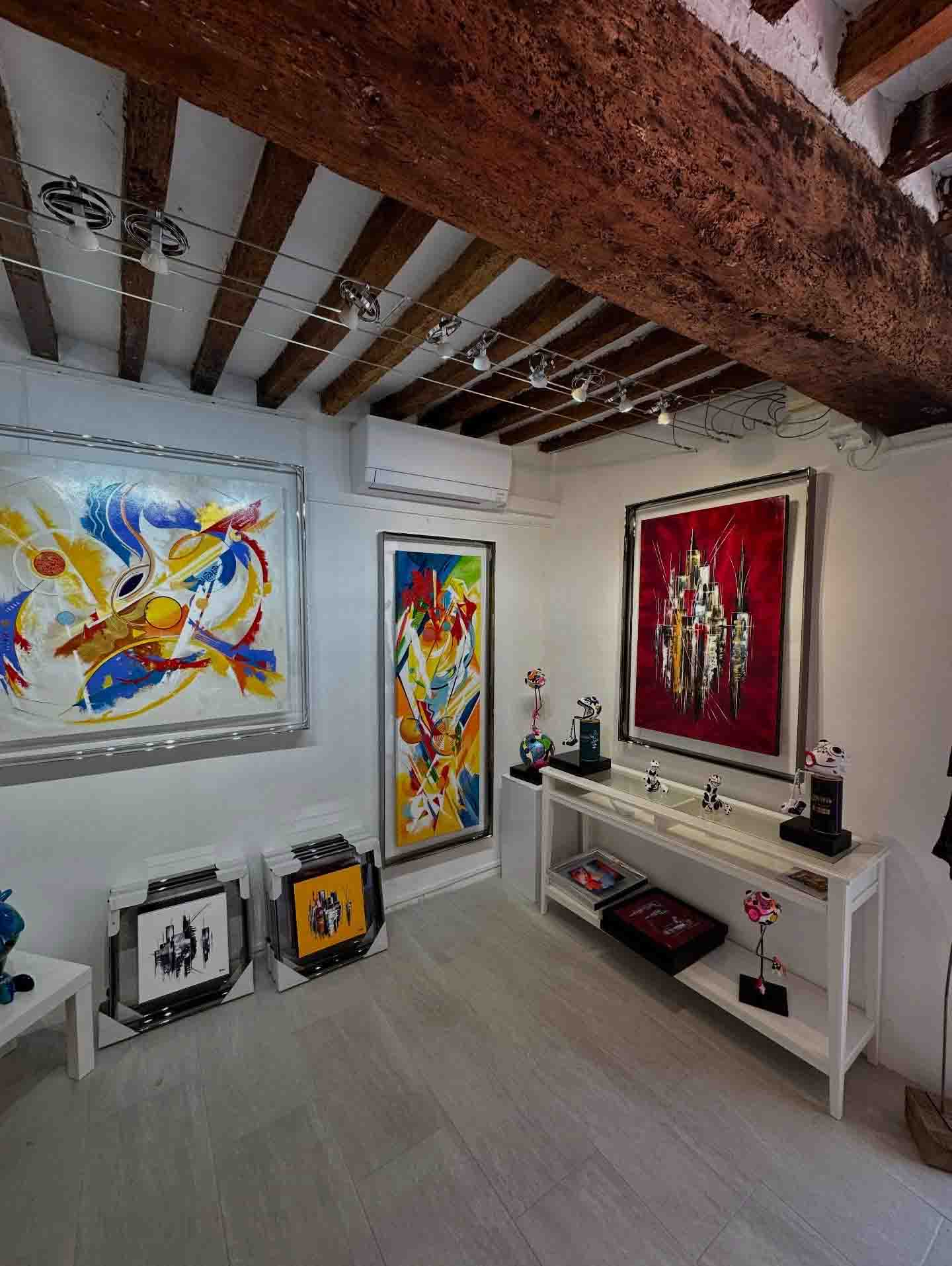 Interior of the Catherine Dumas Perrot Gallery in Lourmarin featuring colourful and contemporary abstract paintings