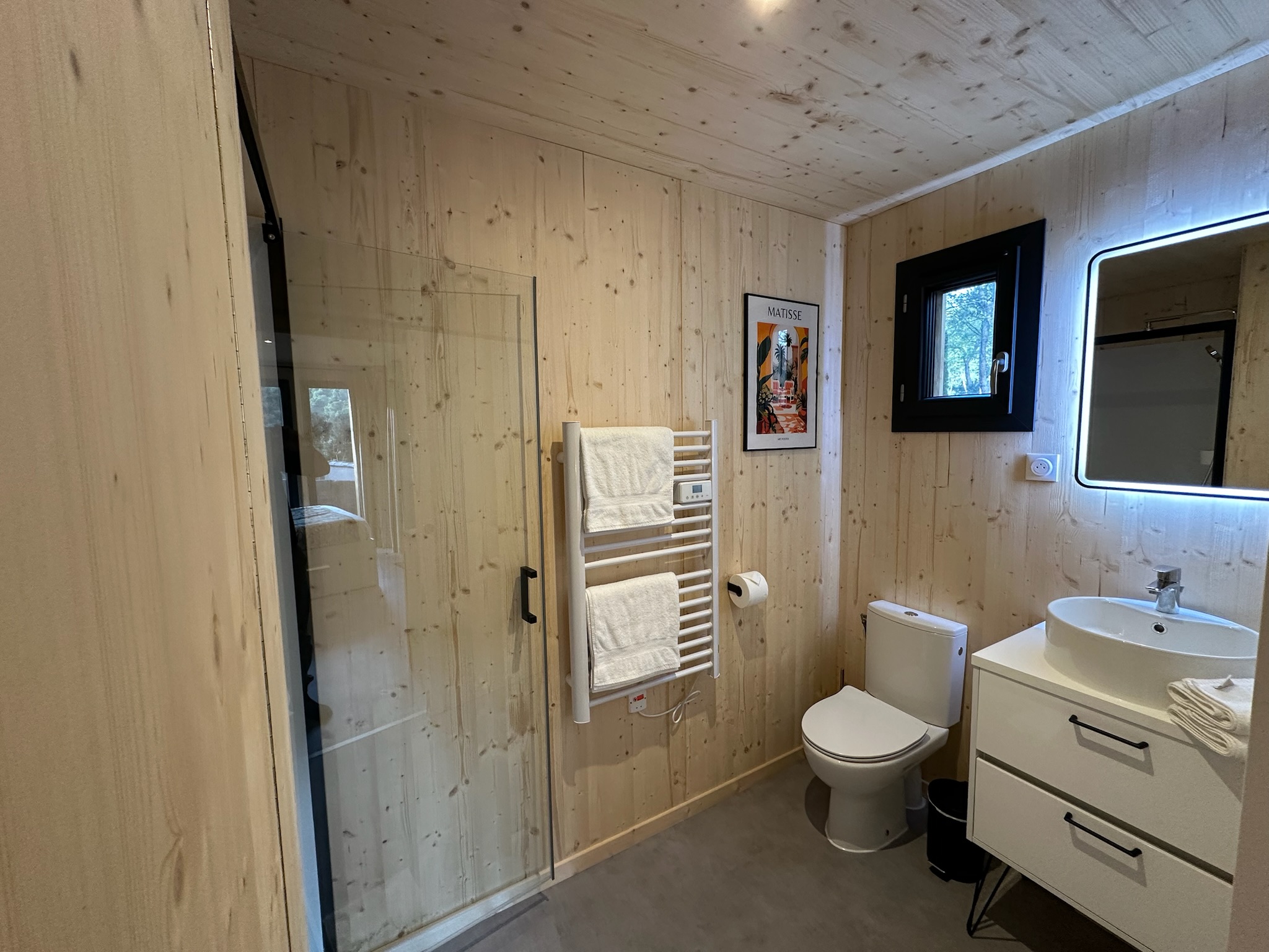 Bathroom at Bird in Provence with glass-enclosed shower, washbasin and toilet