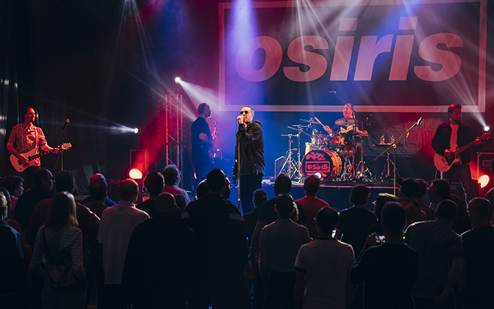 The singer and musicians of Osiris on stage during an Oasis tribute concert