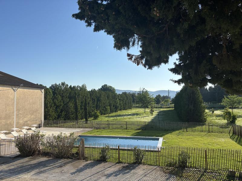 Swimming pool and garden at Maison Poumo in L’Isle-sur-la-Sorgue