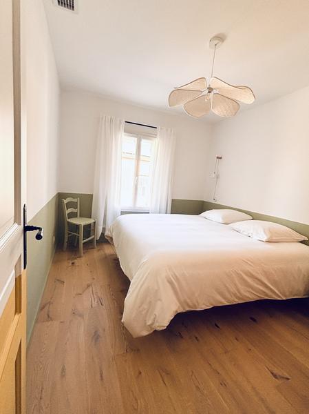 Double bedroom with wooden flooring at Maison Poumo