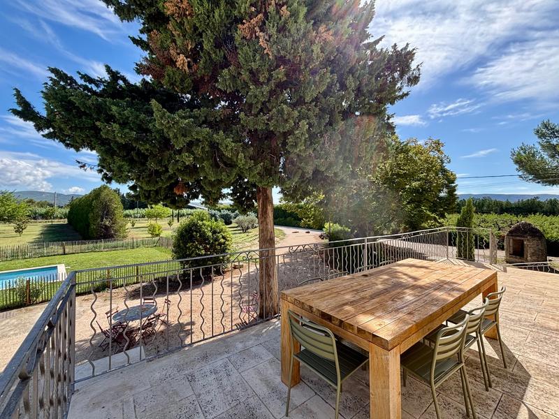 Terrace at Maison Poumo overlooking the garden and the Luberon