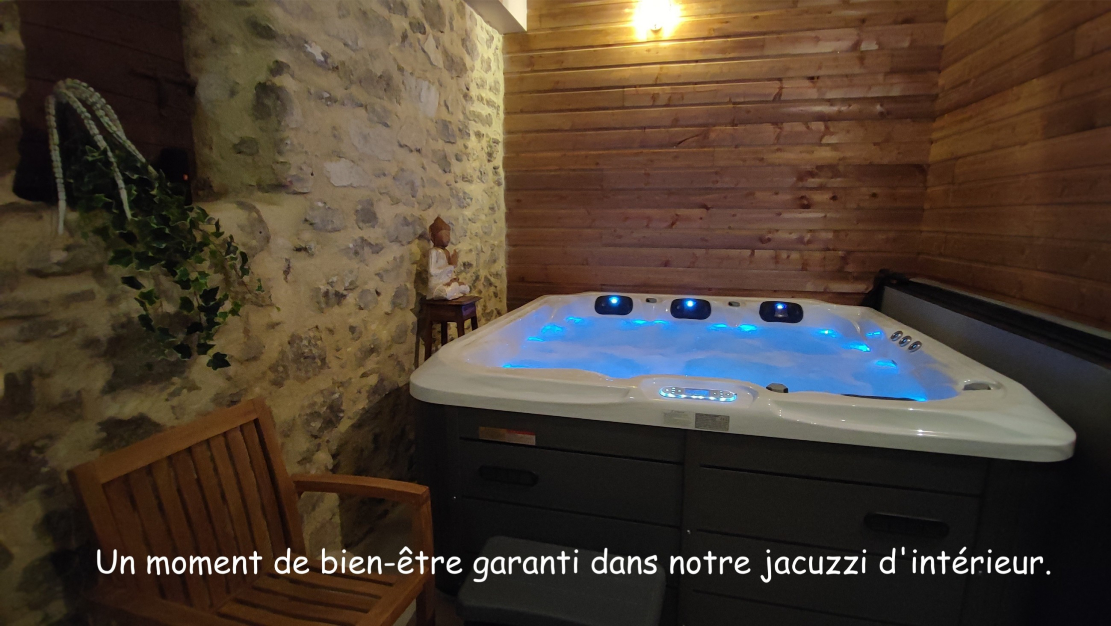 Private four-person indoor jacuzzi in a room with stone and wooden walls