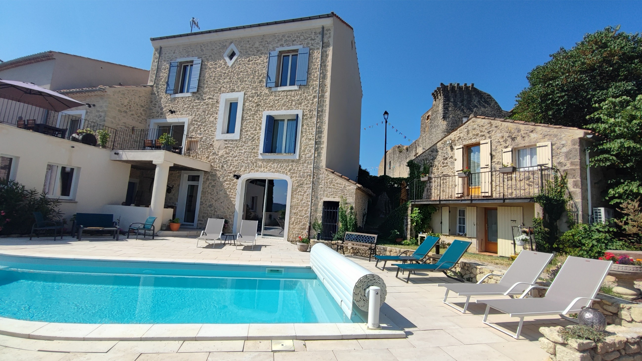 Le Lavoir in Grambois, a stone holiday cottage at the foot of the village ramparts with a shared swimming pool