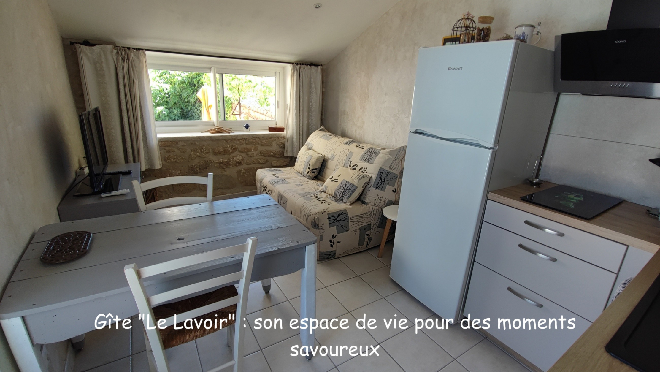 Living area at Le Lavoir holiday cottage with dining space and sofa