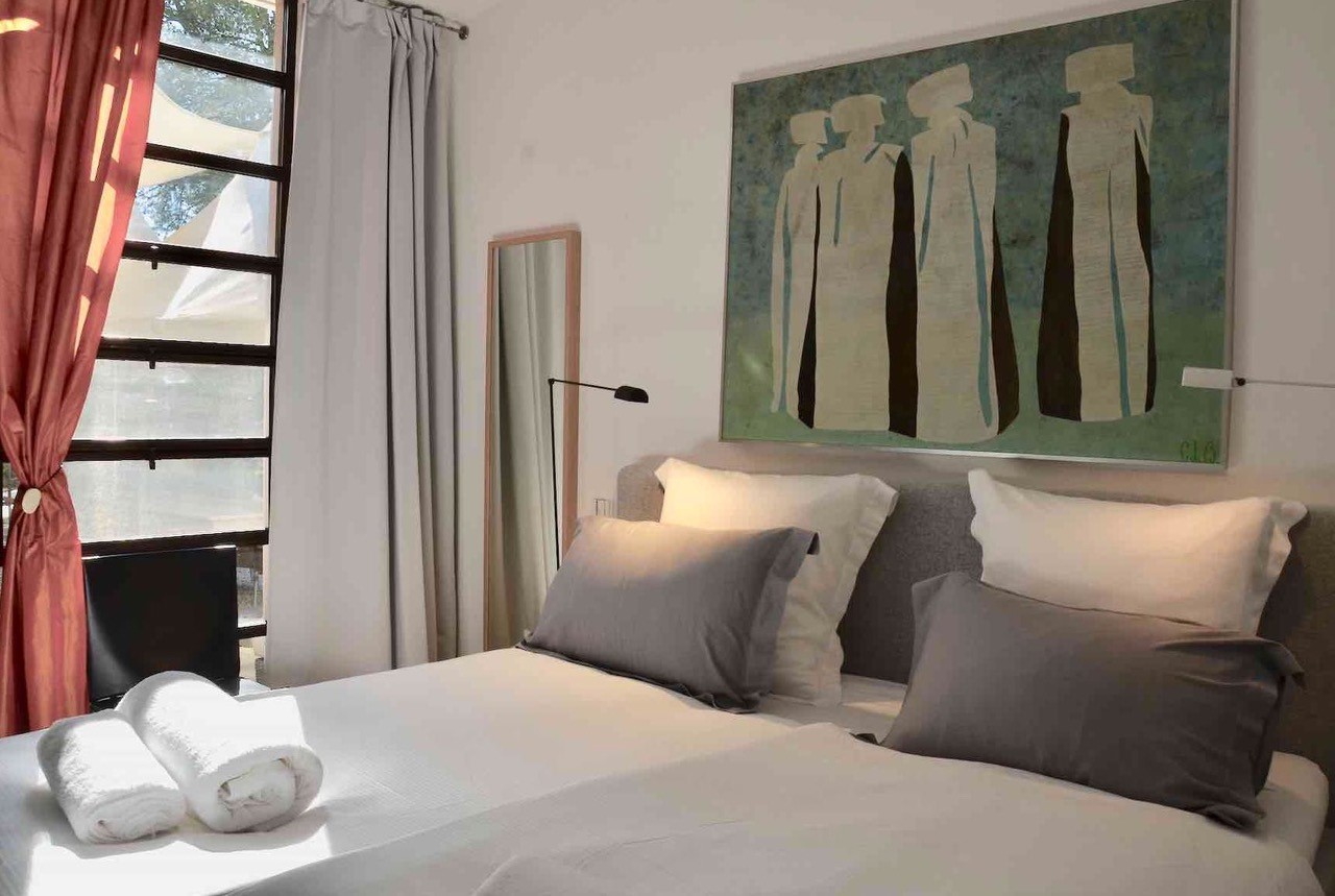 La Suite at Maison Bertuli opening onto the private tree-lined courtyard