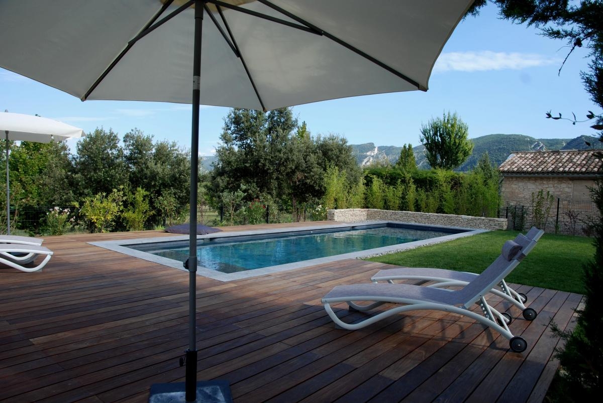 Swimming pool at La Maison Magnarelles in the Luberon Swimming pool at La Maison Magnarelles with wooden terrace in the Luberon