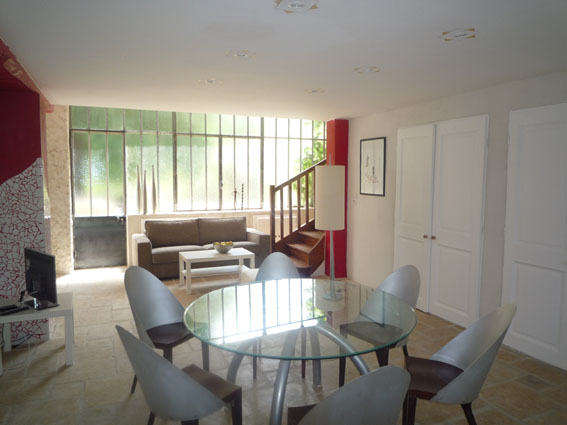 Bright living room with glass roof, lounge and dining area in Sauge & Marjolaine holiday rental