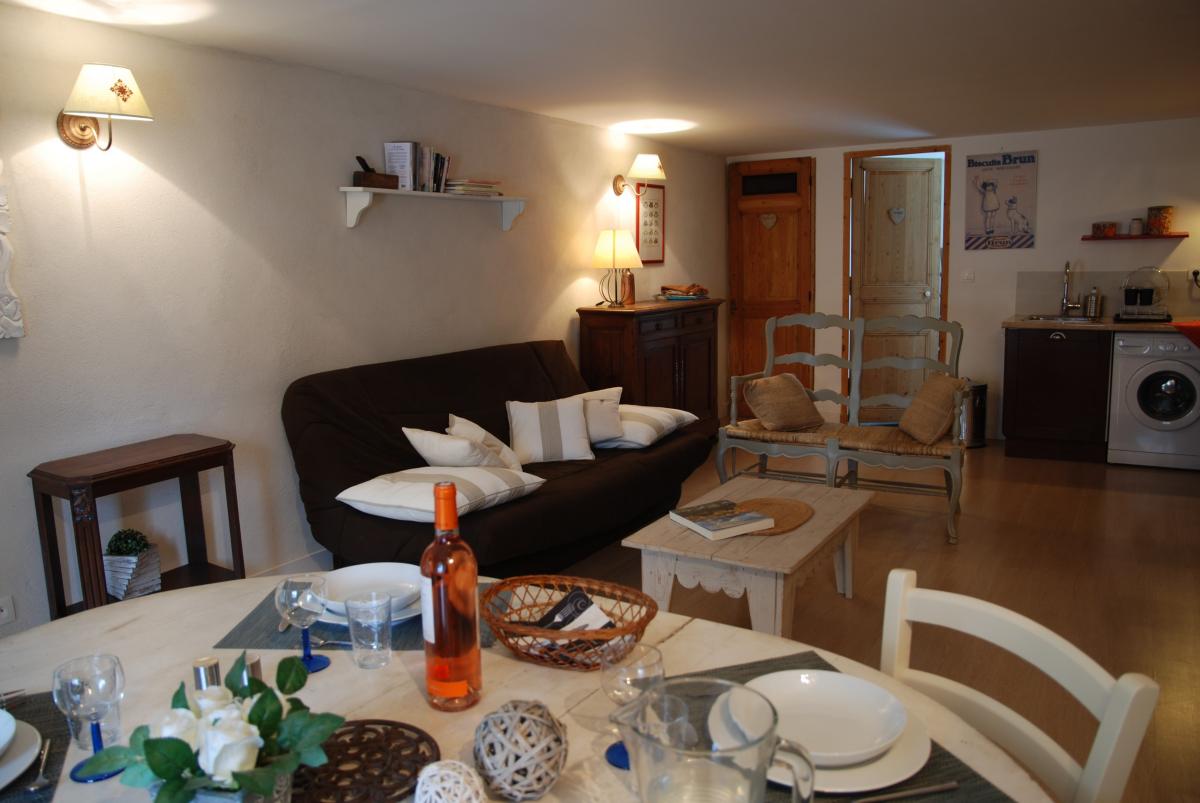 Living room of Les Magnans holiday rental at La Maison Magnarelles Living area of Les Magnans holiday rental with lounge, dining area and open kitchen