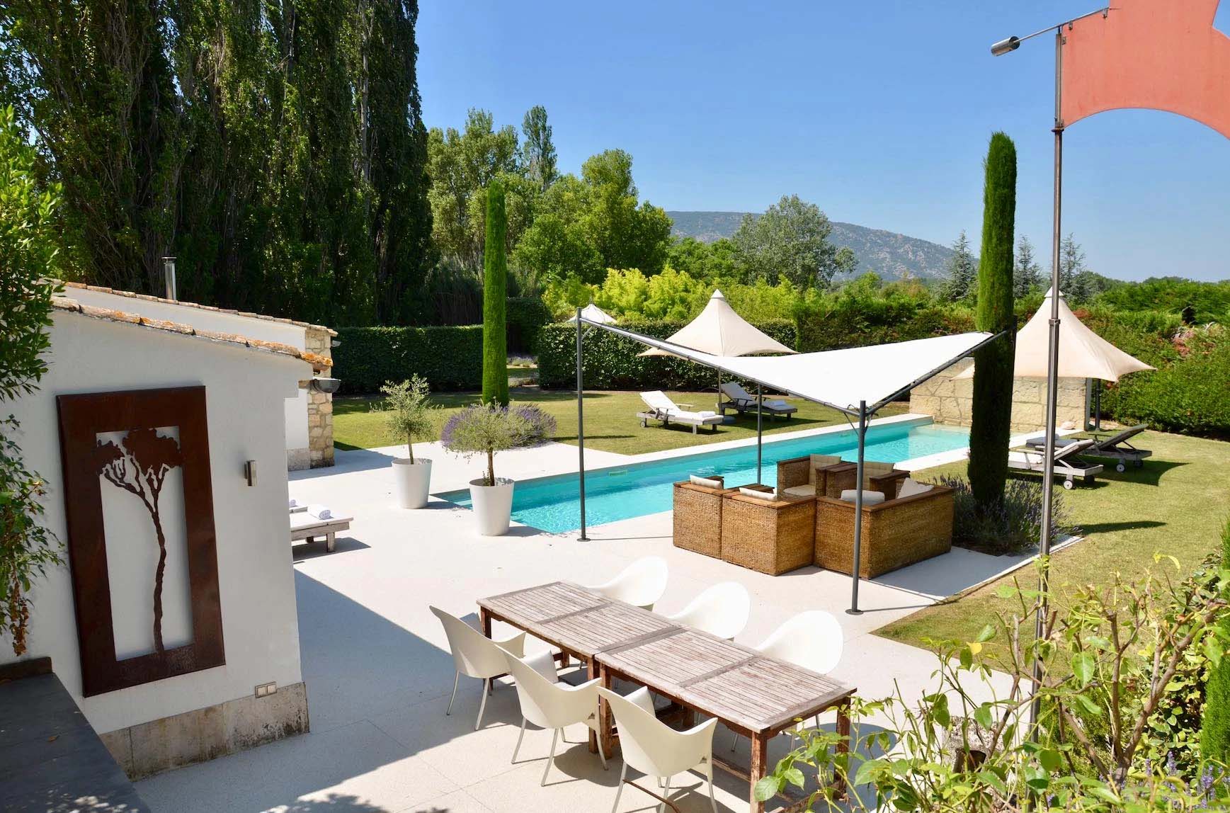 Lap pool and terraces at Les Cerisiers with views over the Luberon hills