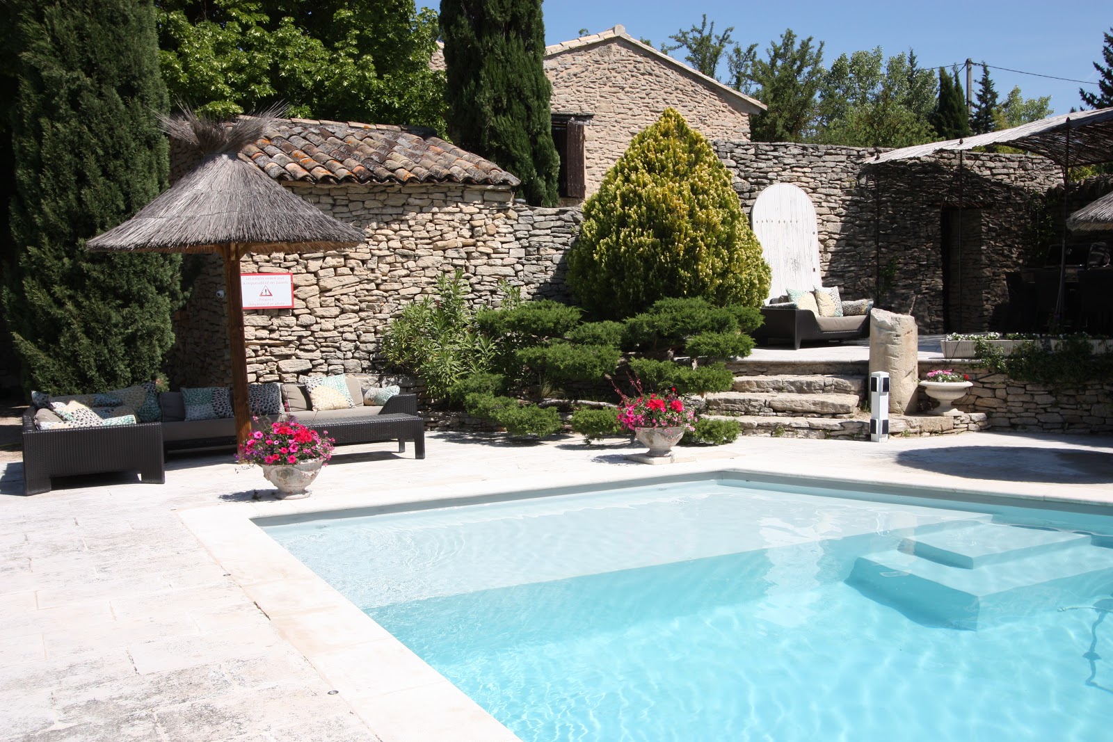 Pool and garden at the bed and breakfast Au Chant des Sorgues in Lagnes