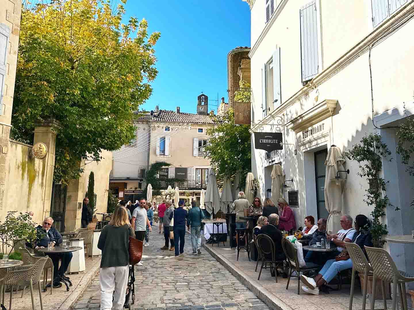 Terrace of Brasserie L'Insolite in a street of the village of Lourmarin